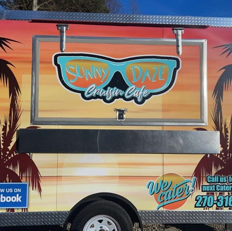 Colorful sunset background on the side of a food truck, with sunglasses showing the name "Sunny Daze"